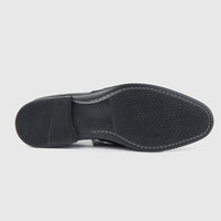 Bulletti men's leather dress slip-on with fringe in black, bottom view showing textured rubber outsole tread.