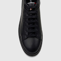 Close-up front view of a Bulletti Men's Black Leather Sneaker, featuring black laces and subtle branding on the side and