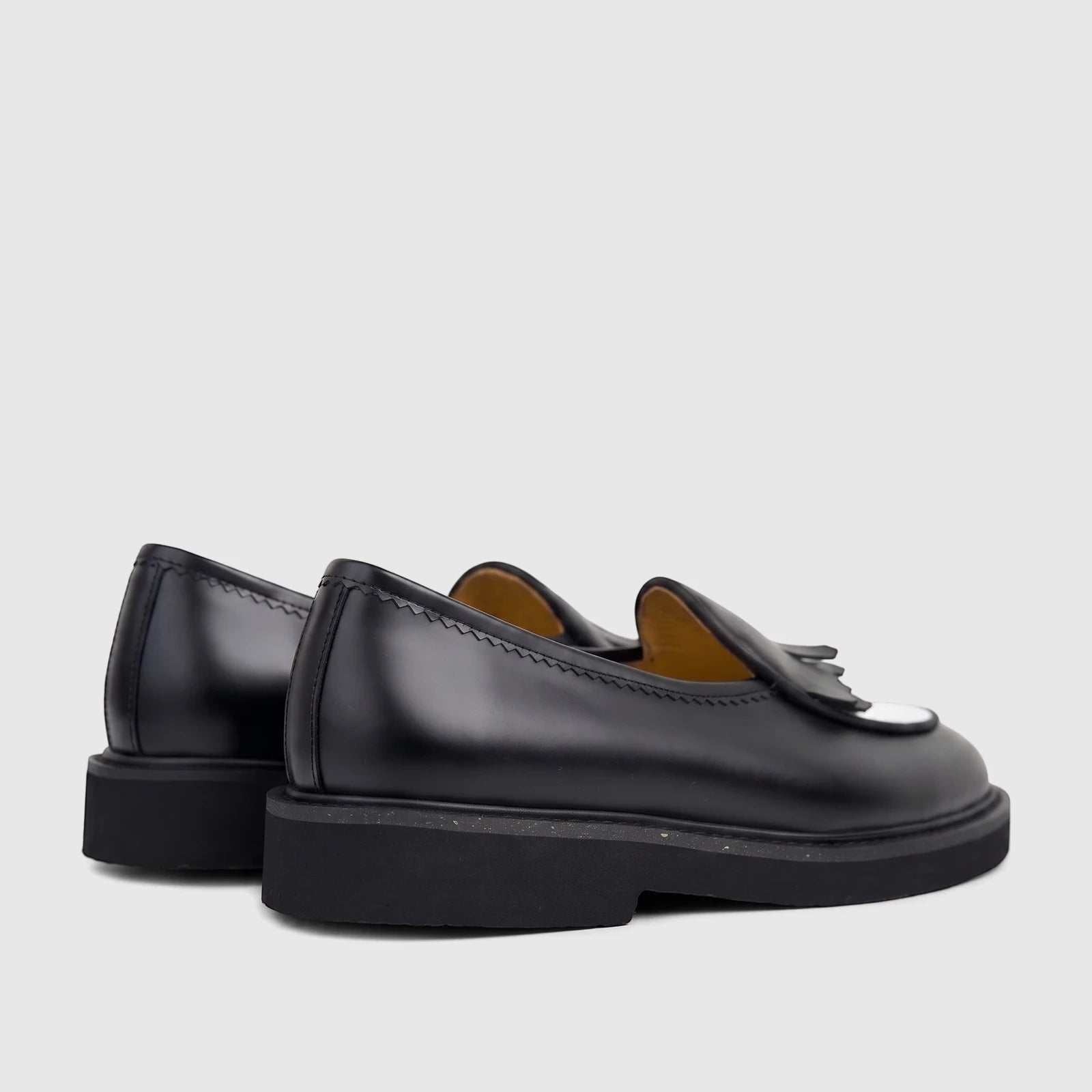 Two Bulletti men's black and white leather chunky sole loafers, B7813M Crosswind, viewed from a rear-side perspective.