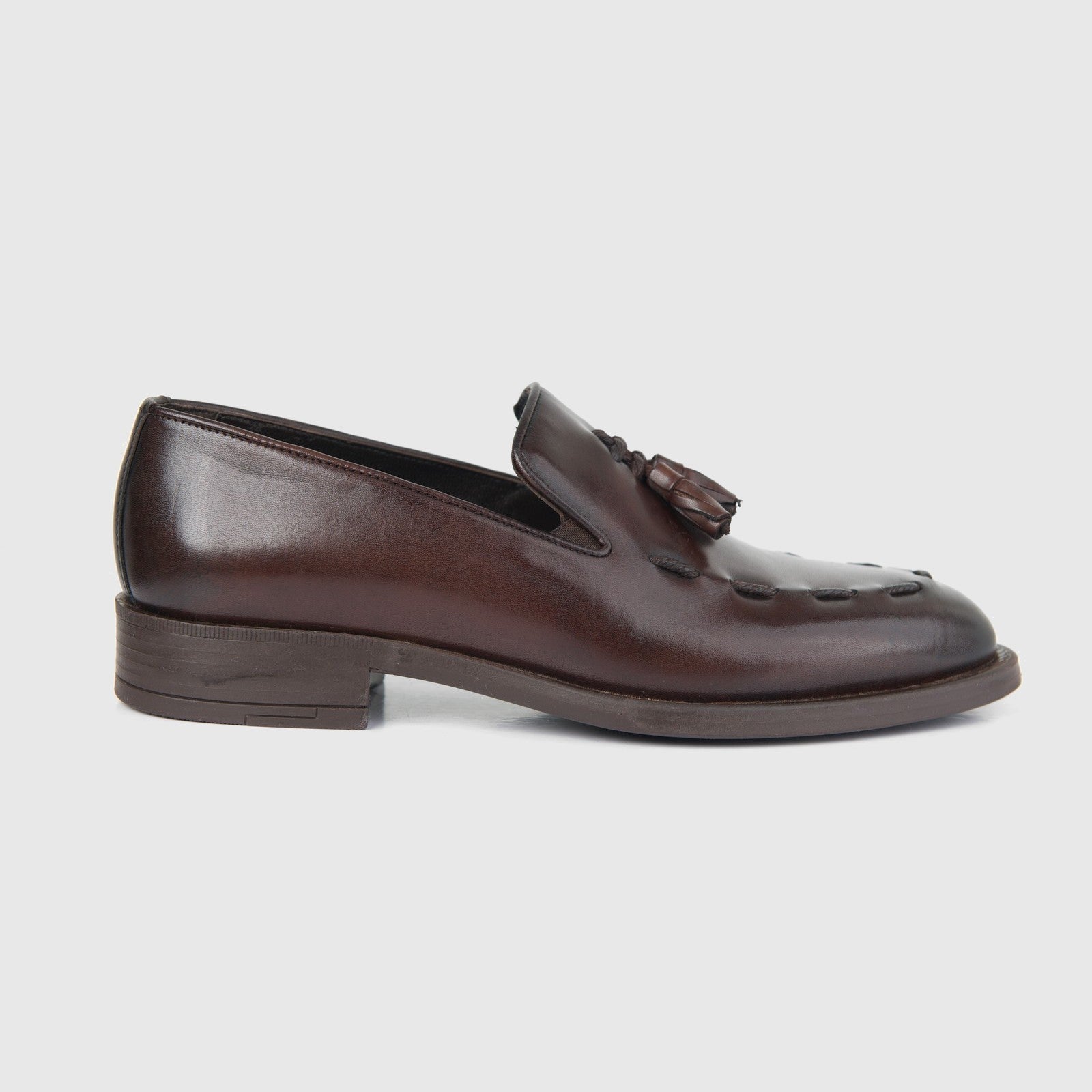 Bulletti men's brown leather dress slip-on loafer with tassel, side view showing stitched apron toe.