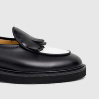 Bulletti men's chunky sole loafer in black and white leather with fringe detail, side view.