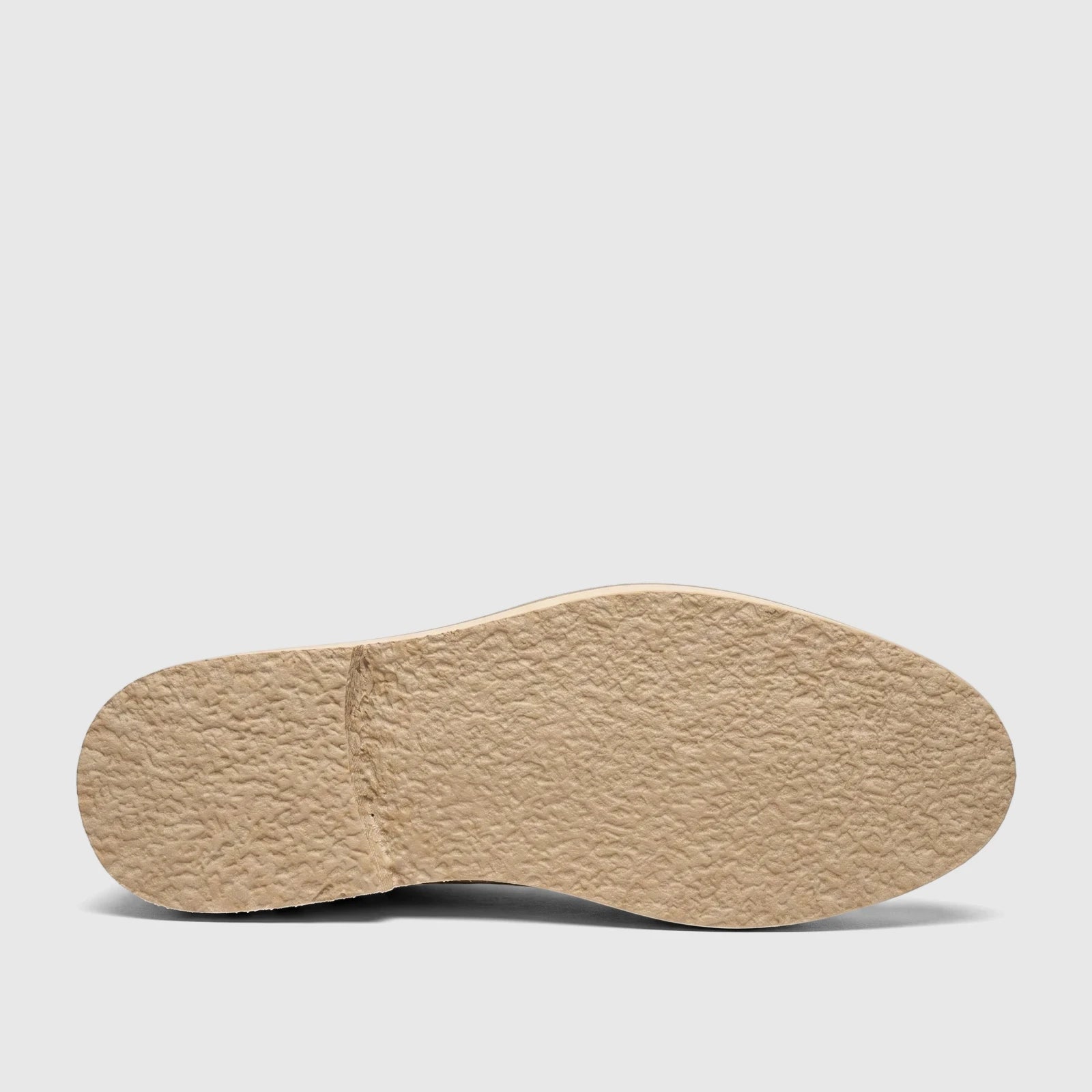 Bottom view of a Bulletti Men's Chunky Sole Loafer in off-white, showcasing the textured, beige rubber sole with a defined
