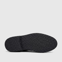 Underside of a black men's chunky sole sandal, showcasing the textured grip and stitching details.