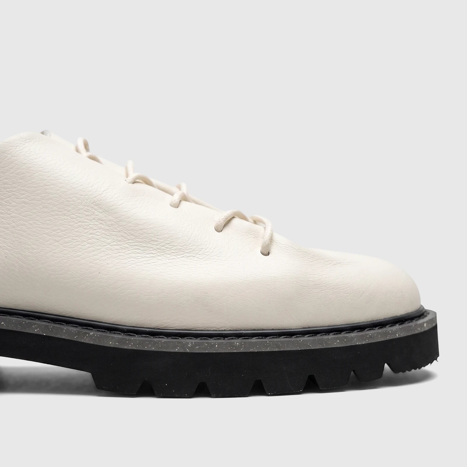 Off-white Bulletti men's leather chunky sole casual lace-up shoe with white laces and black sole, shown from the side.