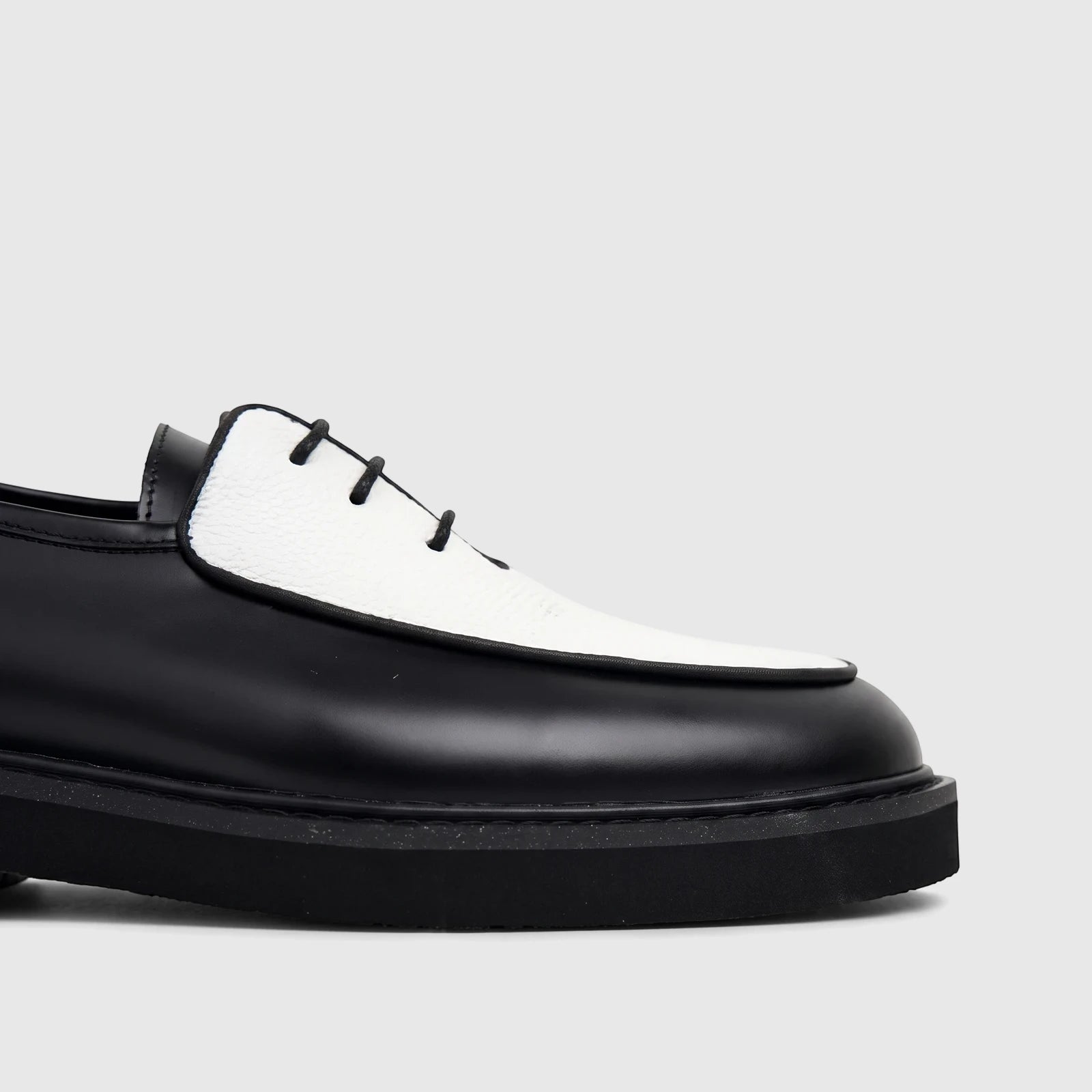 Bulletti Men's Leather Chunky Sole Lace Up shoe in black and white, featuring a textured white vamp and thick black sole.