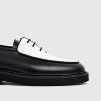 Bulletti Men's Leather Chunky Sole Lace Up shoe in black and white, featuring a textured white vamp and thick black sole.