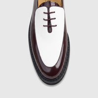 Close-up top view of a Bulletti Men's Leather Chunky Sole Lace Up shoe in burgundy and white, featuring a glossy and