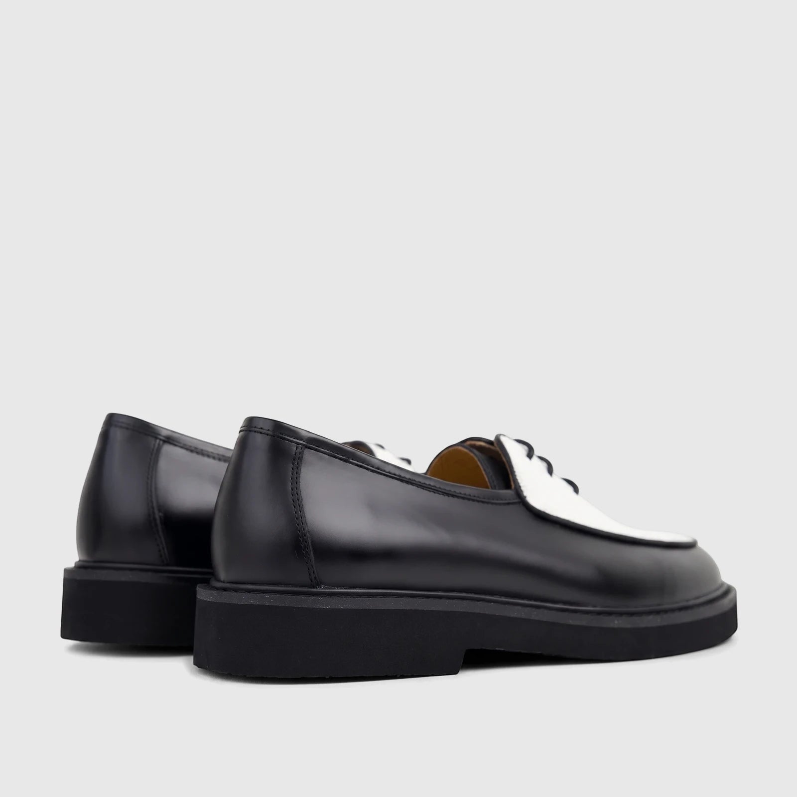 Bulletti Men's black and white leather lace-up shoes with chunky soles, shown from a side-rear angle.