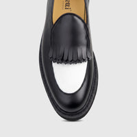 Front view of a Bulletti Men's Leather Chunky Sole Loafer, featuring a black and white design with decorative fringe.
