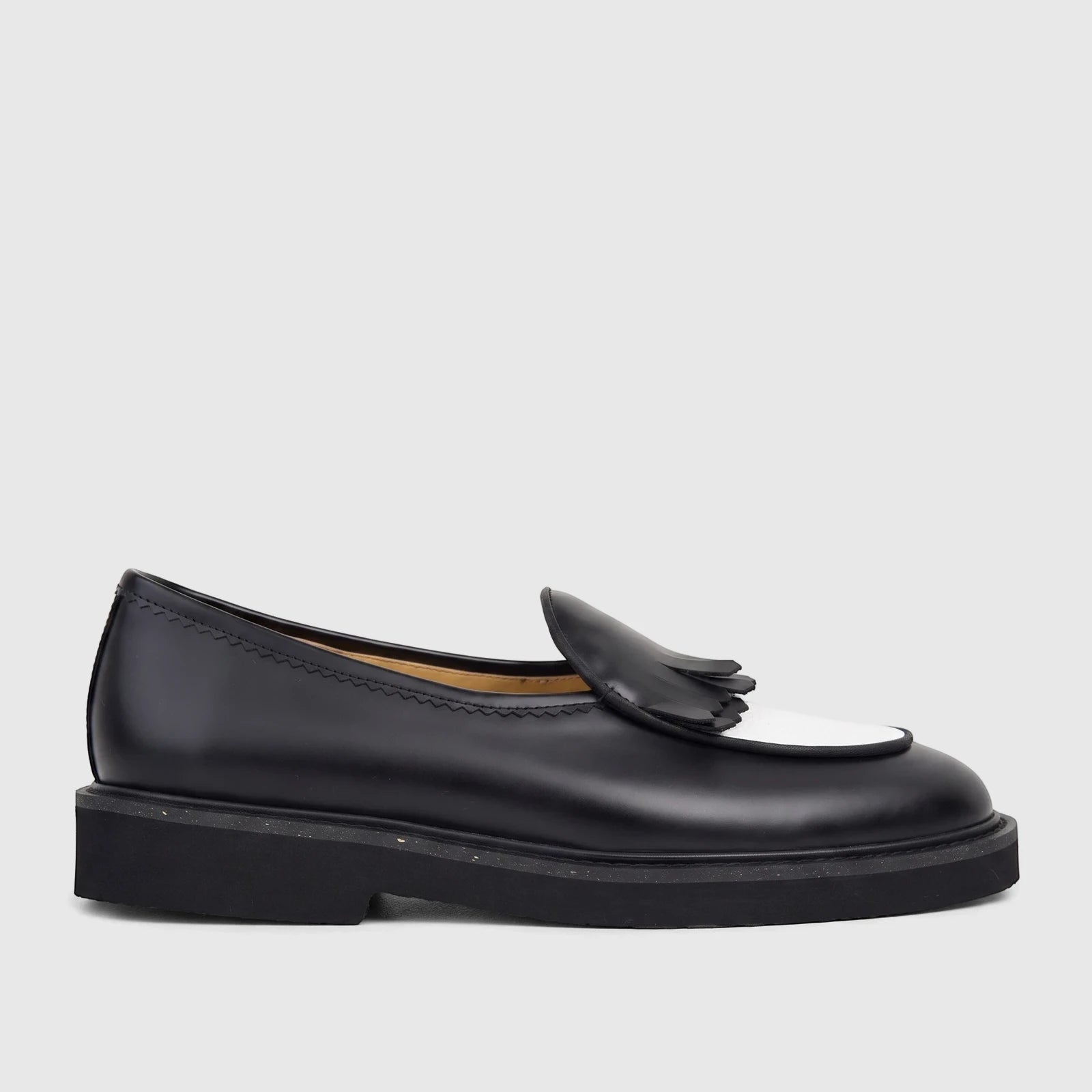 Bulletti Men's Leather Chunky Sole Loafer in black and white, featuring a fringe detail and a durable sole, presented in a