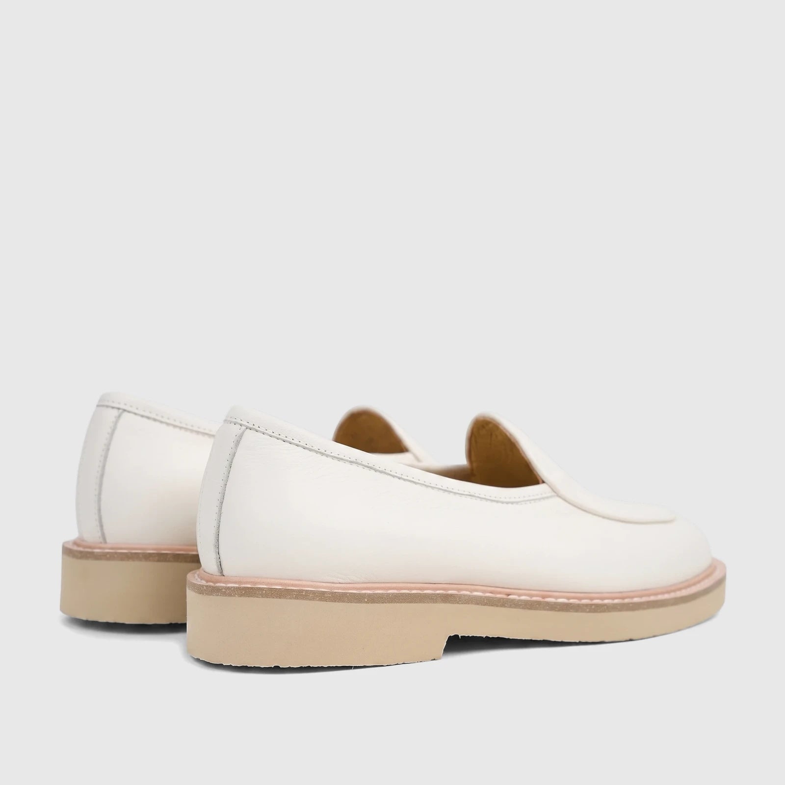 Pair of Bulletti Men's Leather Chunky Sole Loafers in off-white, shown from a side-rear view. The shoes feature visible