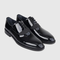A pair of glossy black Bulletti Men's Leather Dress Lace Up 128-21 Black Patent shoes, angled to show the sleek design and
