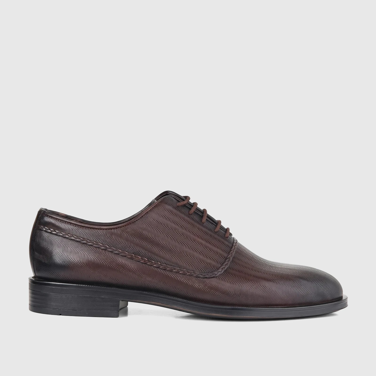 Bulletti Men's Leather Dress Lace Up shoe in brown, featuring a distinctive wavy embossed pattern, captured from a side view.
