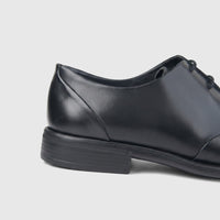 Bulletti Men's Leather Dress Lace Up Shoe in black, shown from a side view highlighting the heel and midfoot design.
