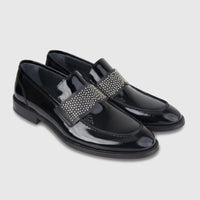 Bulletti men's leather dress slip-on loafers in black patent with studded strap, pair shown from side angle.