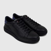 A pair of black Bulletti men's leather sneakers featuring blue heel accents and textured ridged soles, seen from a slightly
