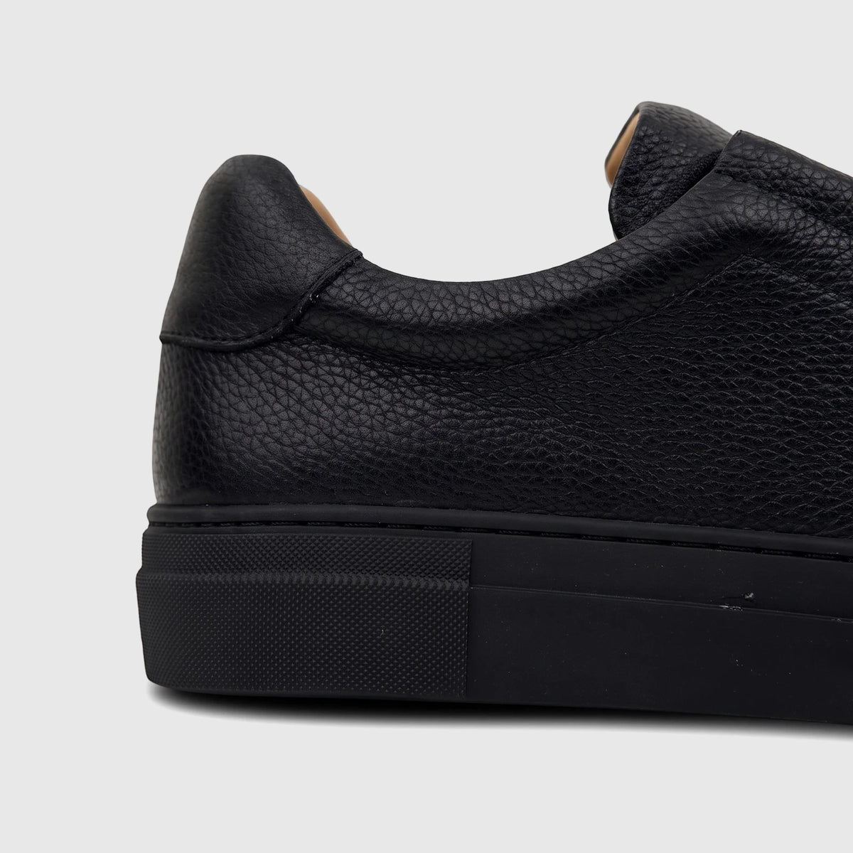 Close-up side view of a Bulletti Men's Leather Sneaker Black HASM-006, highlighting its pebbled texture and stitching