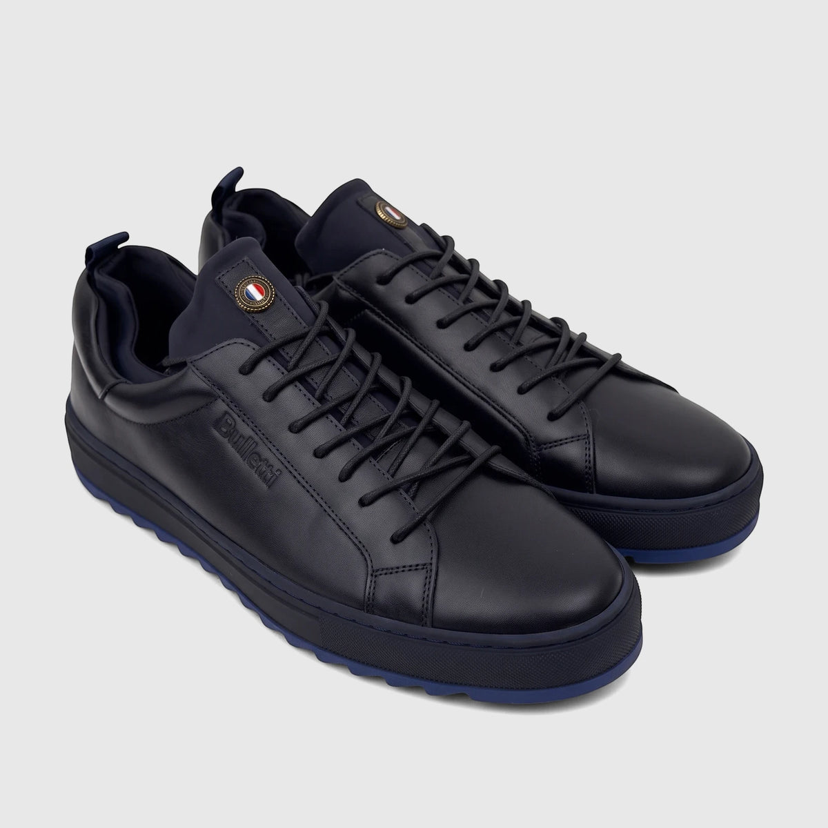 Pair of Bulletti Men's Leather Sneaker Dark Blue HASM-001, featuring black laces and blue accents, displayed on a flat