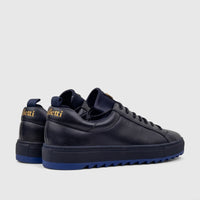 Dark blue Bulletti men's leather sneakers, model HASM-001, with royal blue soles and gold heel logos, shown from a rear-side