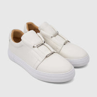 A pair of white Bulletti men's leather slip-on sneakers with silver hardware detail, viewed from a slightly elevated side