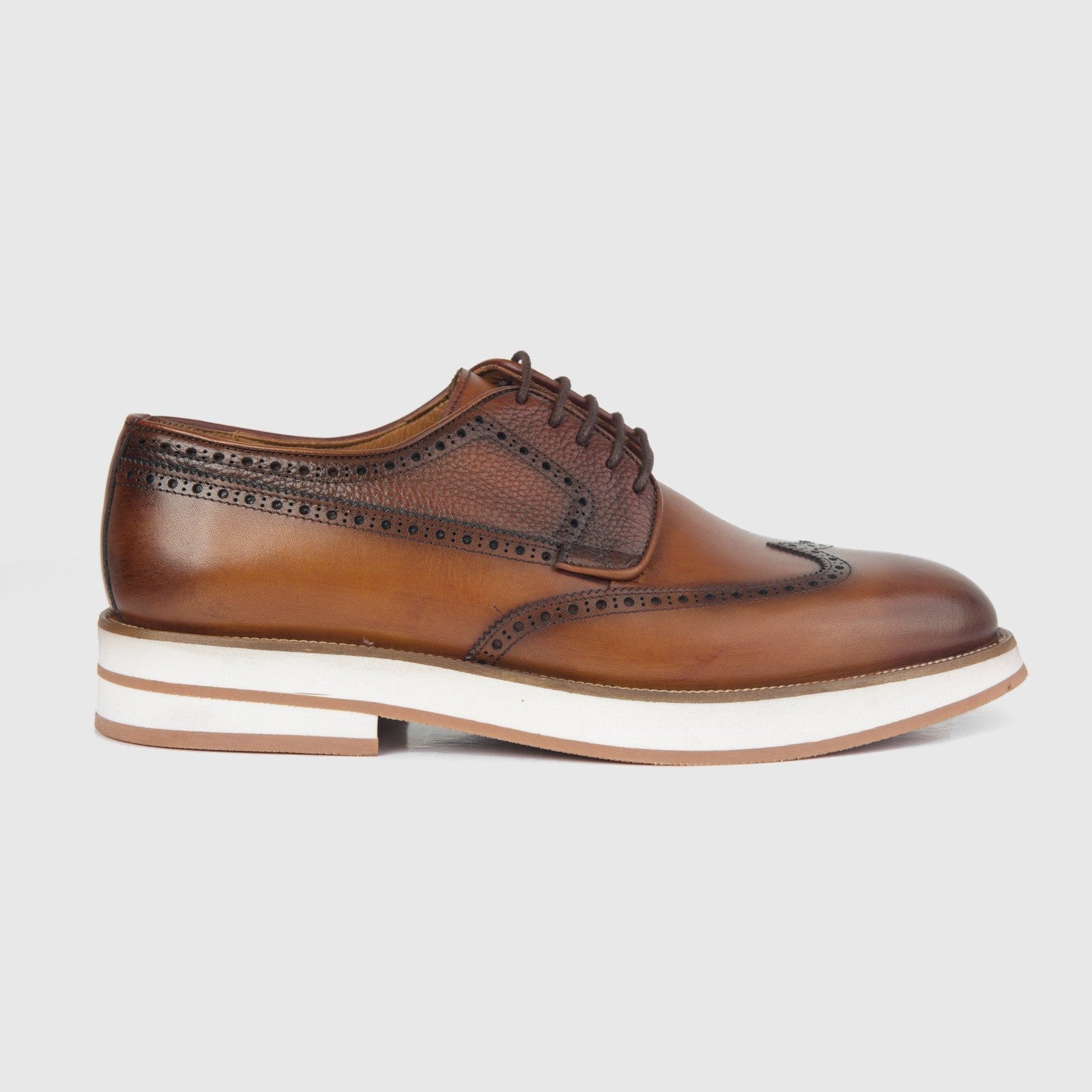Bulletti men's leather chunky sole lace up brogue shoe in tan, side view with perforated detailing and white sole