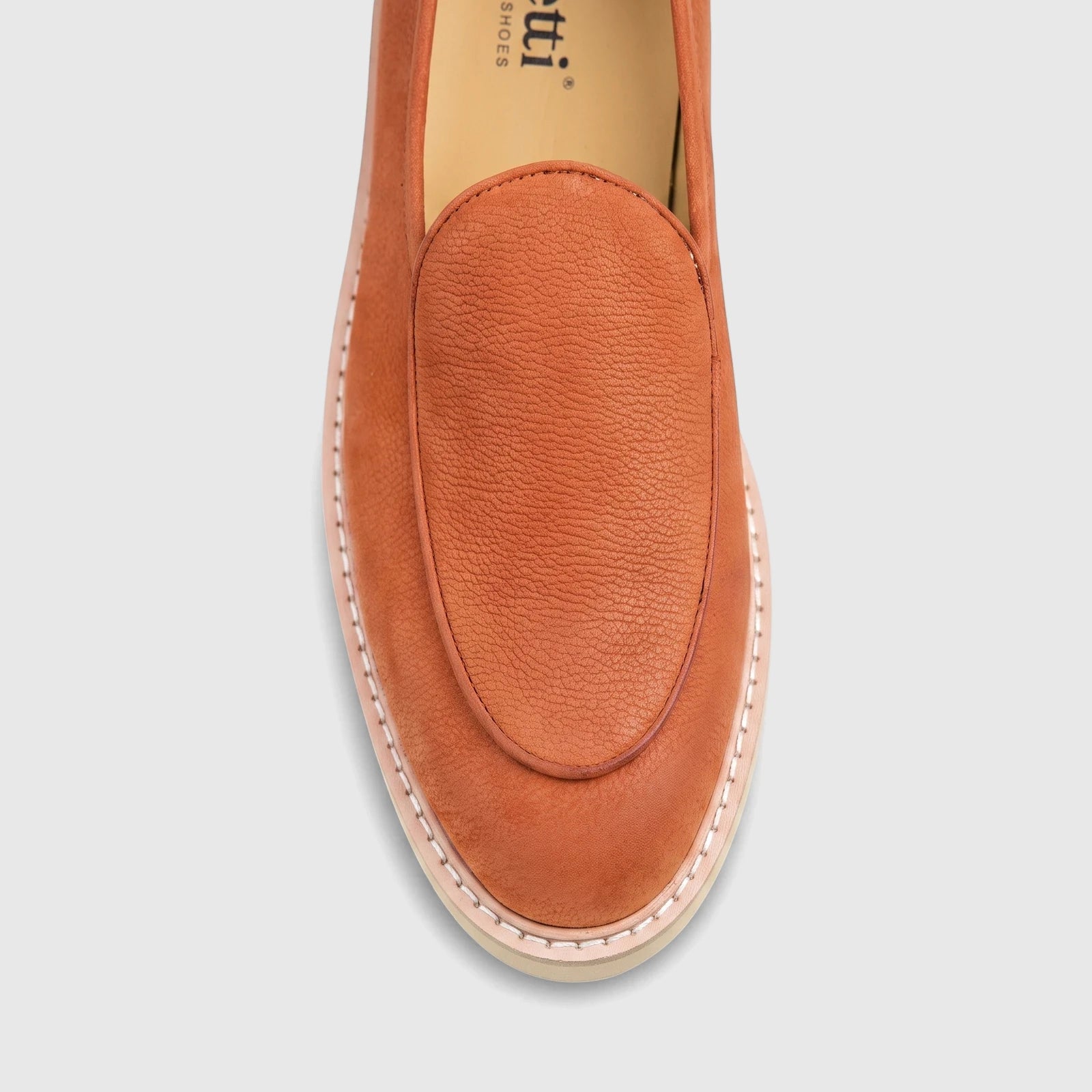 Close-up of a Bulletti Men's Mariner Orange leather chunky sole loafer, showcasing the textured leather and white stitching.