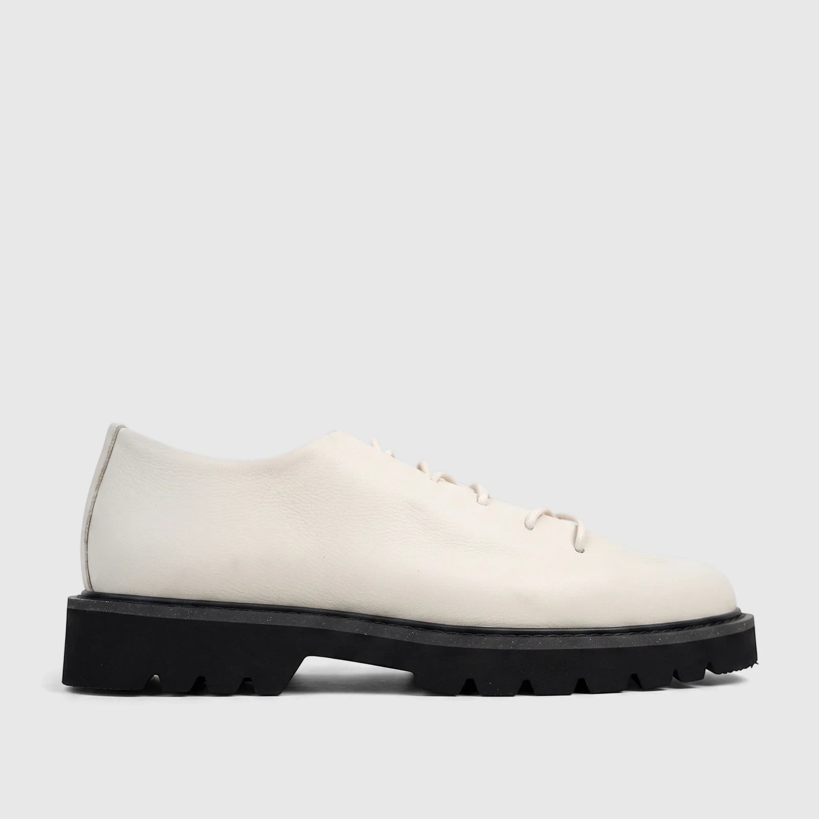 Side view of a Bulletti Men's Seawolf Off White leather casual lace-up shoe with a chunky black sole, presented on a white