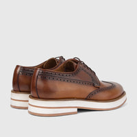 Bulletti Men's tan leather chunky sole lace-up brogue shoes, with intricate broguing and white platform soles, rear view.