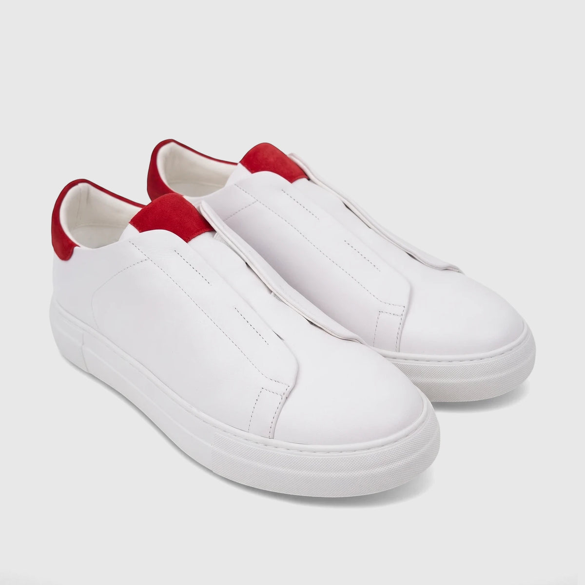 Bulletti Men's white leather slip-on sneakers with red accents, photographed at an angle.