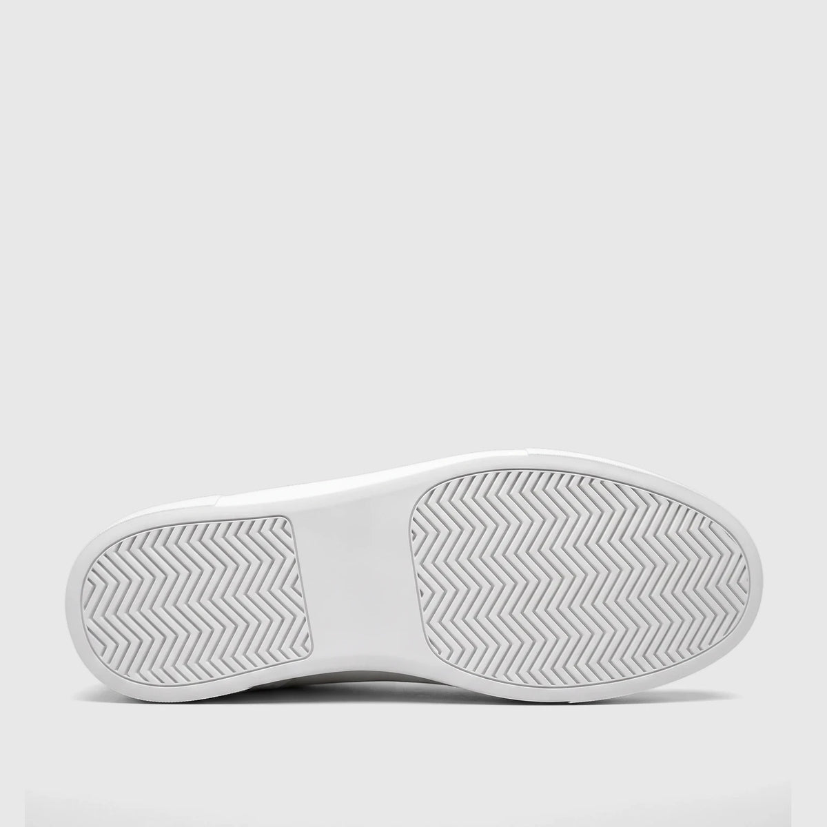 Bottom view of a Bulletti Men's white leather sneaker, showcasing its textured sole with a chevron pattern.