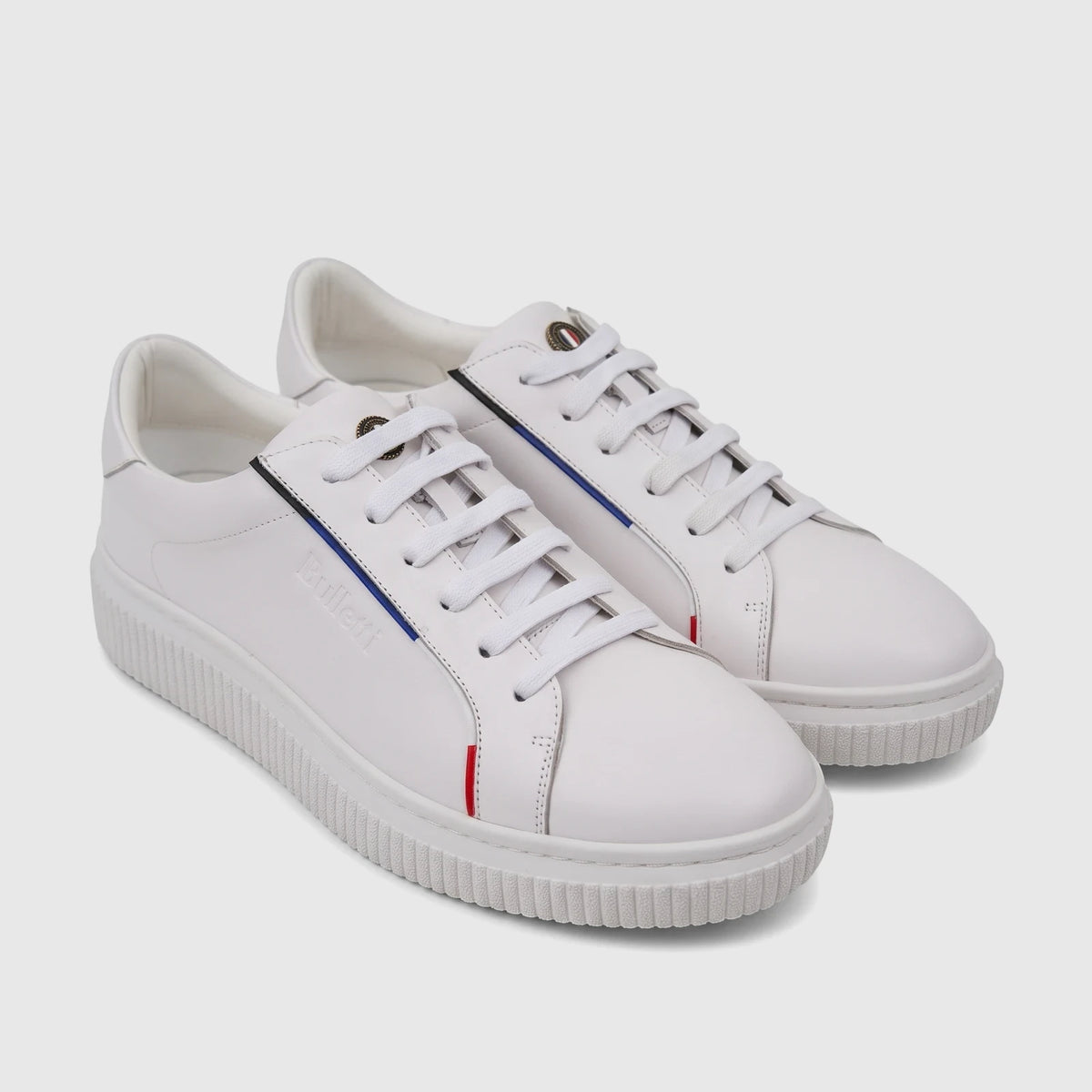 Pair of white leather men's Bulletti sneakers with contrasting red and blue stripes and white laces.