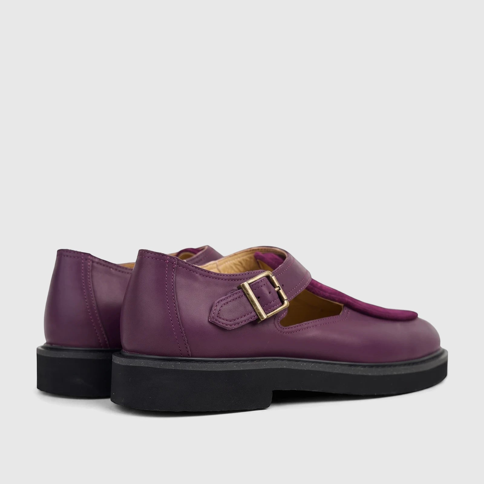 Pair of Bulletti Unisex B7818M Majesty Purple leather chunky sole sandals with a suede T-strap, shown from a side-back view.