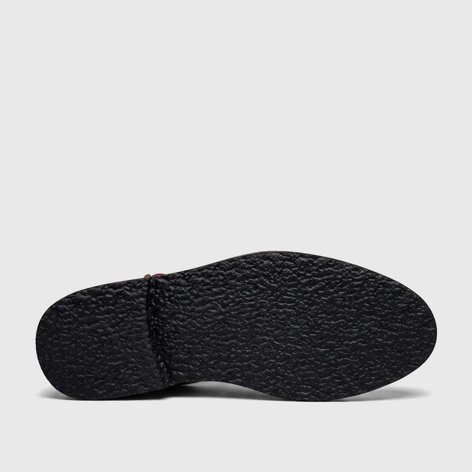 Underside view of a Bulletti Unisex chunky sole sandal, showcasing its dark, textured sole and stitched heel in majesty
