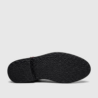 Underside view of a Bulletti Unisex chunky sole sandal, showcasing its dark, textured sole and stitched heel in majesty