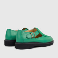 Pair of green leather unisex chunky sole sandals with brass buckles, viewed from a rear-side angle on a white background.