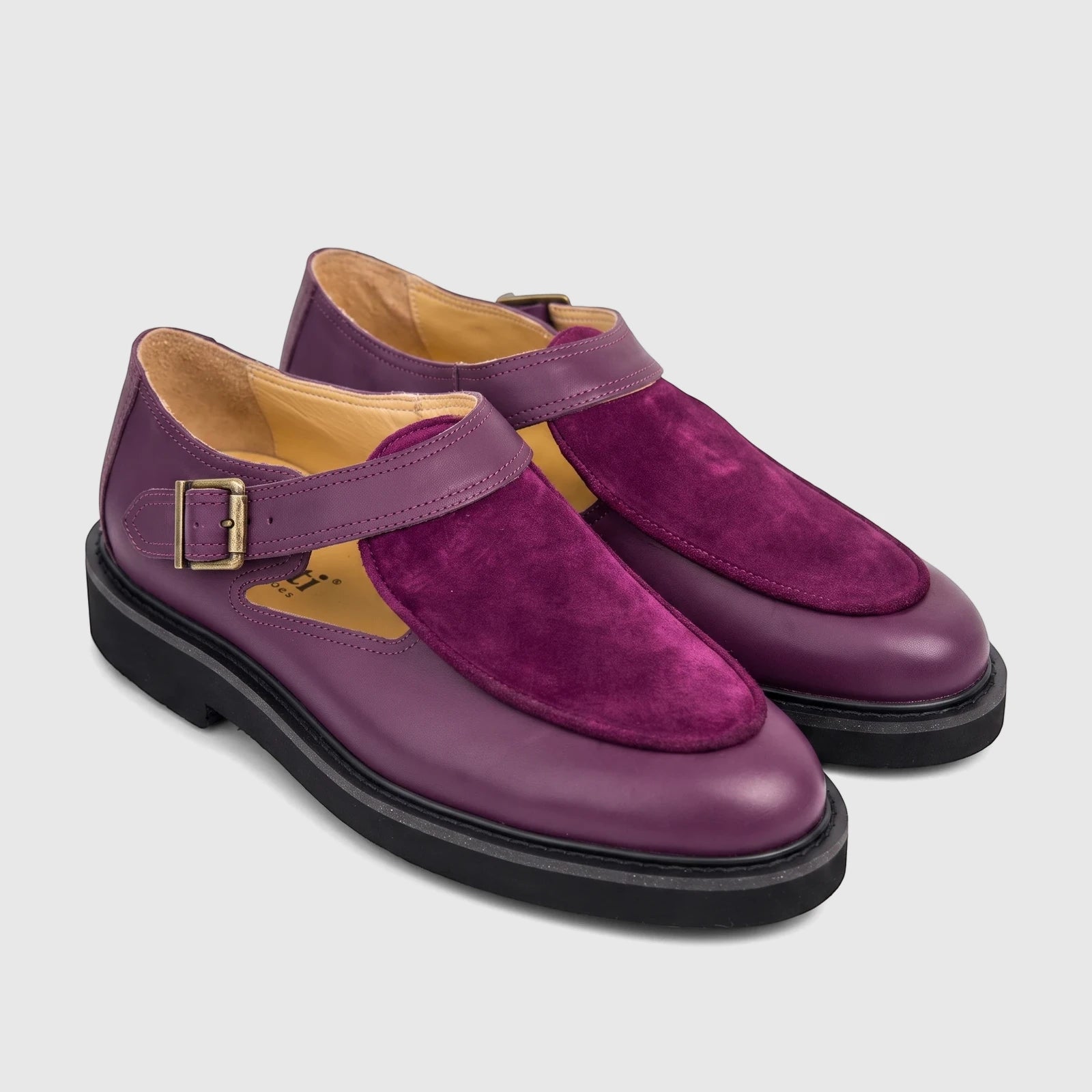 Pair of Bulletti Unisex Majesty Purple Suede and leather chunky sole sandals with brass buckles on a white background.