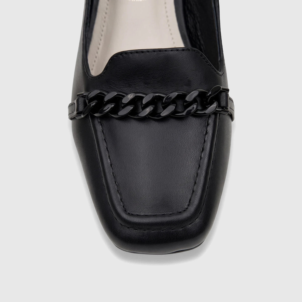 Close-up of a black leather Capelli Rossi ladies' slingback block heel court shoe, featuring a square toe and a decorative