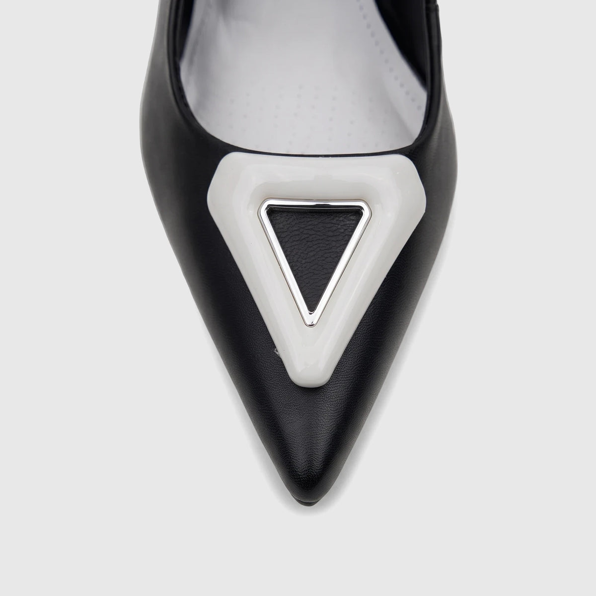 Close-up of a black leather Capelli Rossi slingback court shoe with a pointed toe and a white and silver triangular