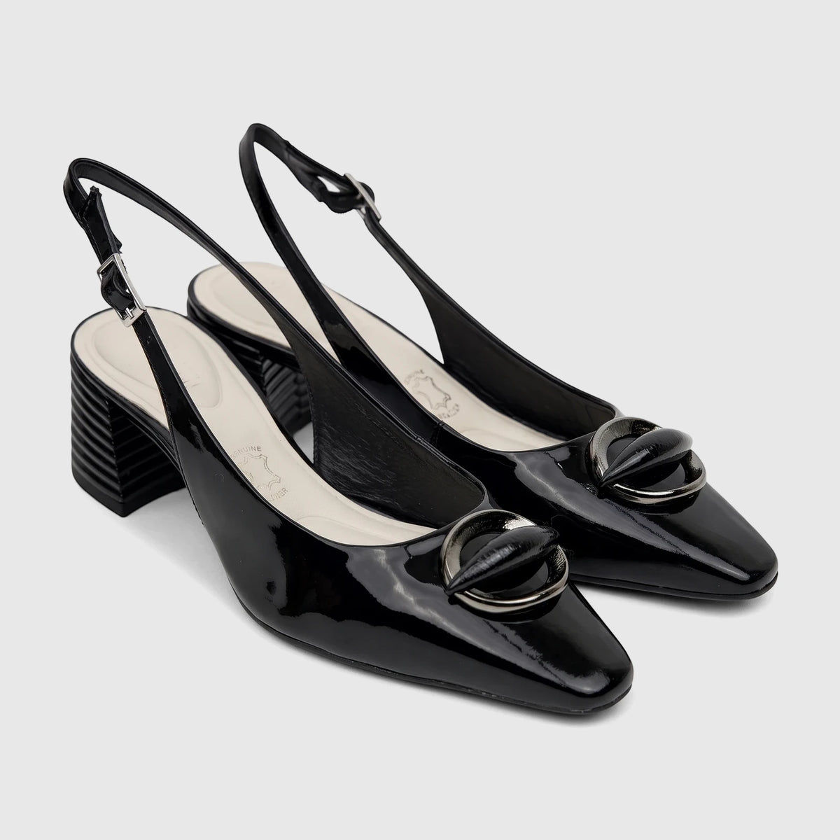 A pair of black patent leather Capelli Rossi slingback block heel court shoes with decorative metallic hardware and stacked