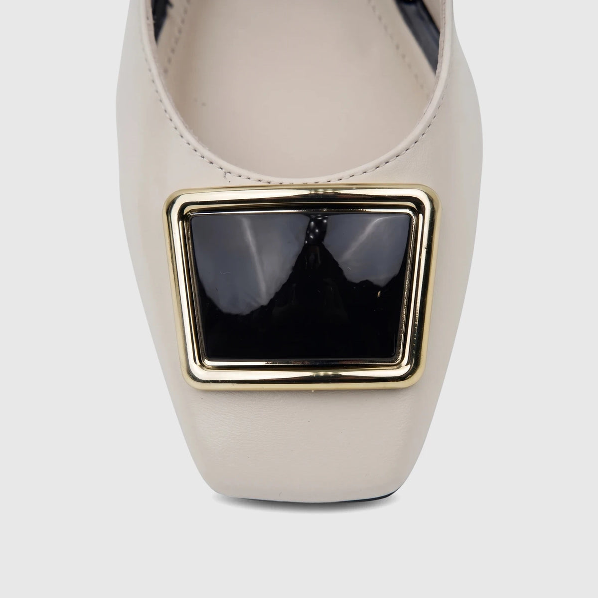 Close-up of a Capelli Rossi ladies' bone leather shoe, featuring a square toe and a prominent rectangular gold-framed black