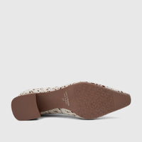 Bottom view of a Capelli Rossi white and brown cow print leather block heel court shoe, showcasing the textured sole and