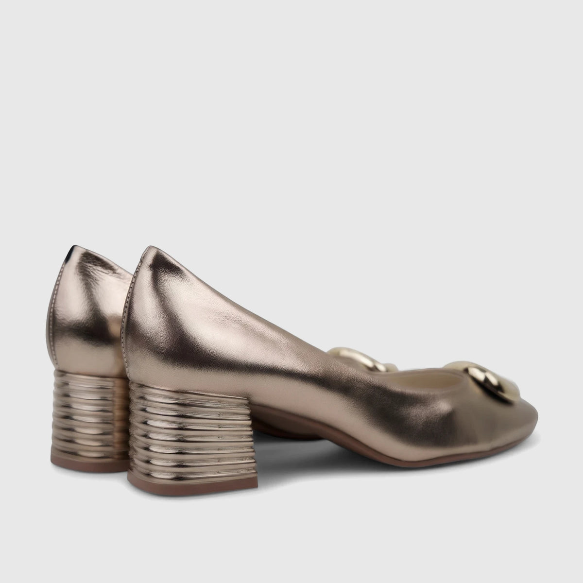 Capelli Rossi gold metallic leather block heel court shoes, viewed from a side-back angle, showcasing the ribbed block heels.