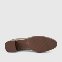 A close-up view of the brown rubber sole of a gold Capelli Rossi leather ladies block heel court shoe, featuring the brand