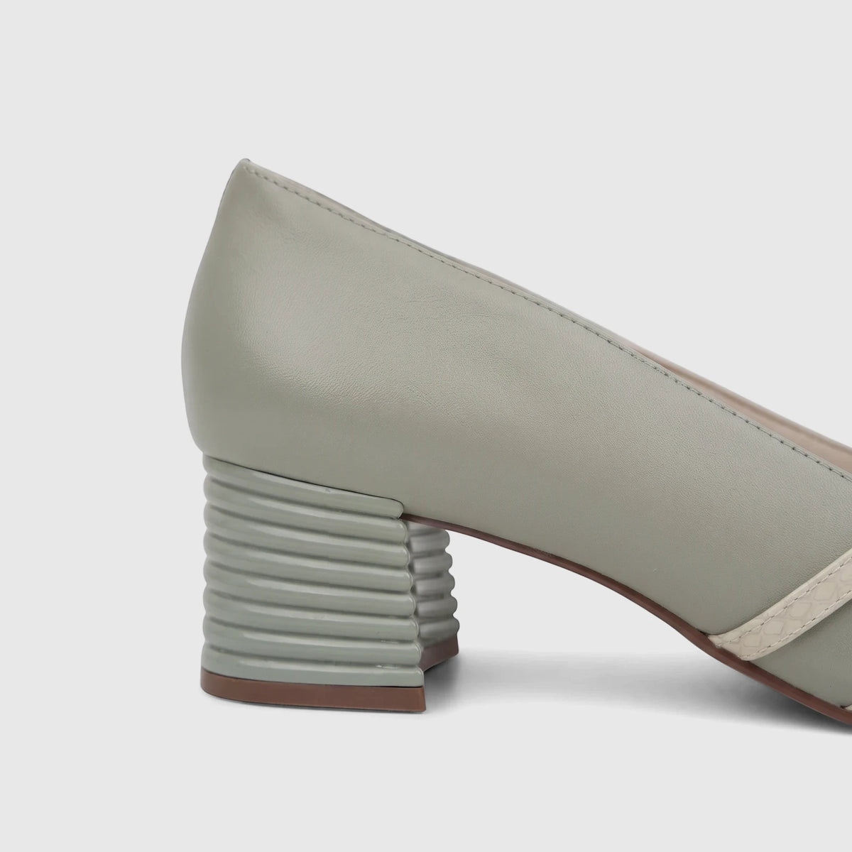 Side view of a green leather Capelli Rossi ladies' block heel court shoe featuring a ribbed heel and cream-colored straps.
