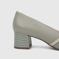 Side view of a green leather Capelli Rossi ladies' block heel court shoe featuring a ribbed heel and cream-colored straps.