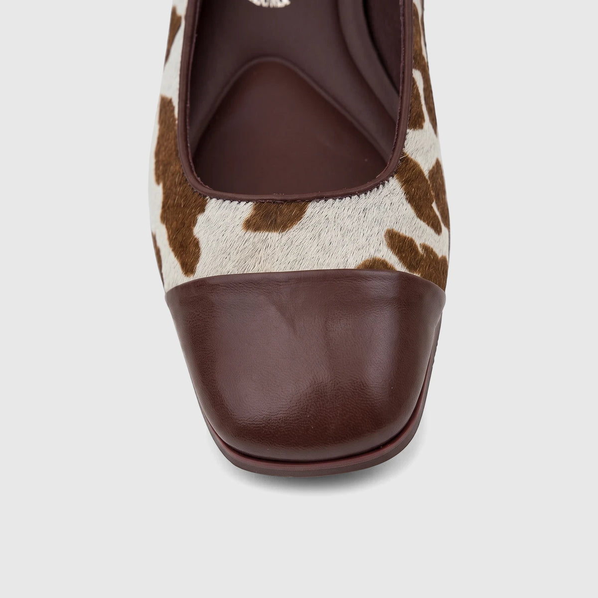 Front view of a Capelli Rossi Ladies Block Heel Court shoe featuring a brown cow print fur upper and a brown leather square
