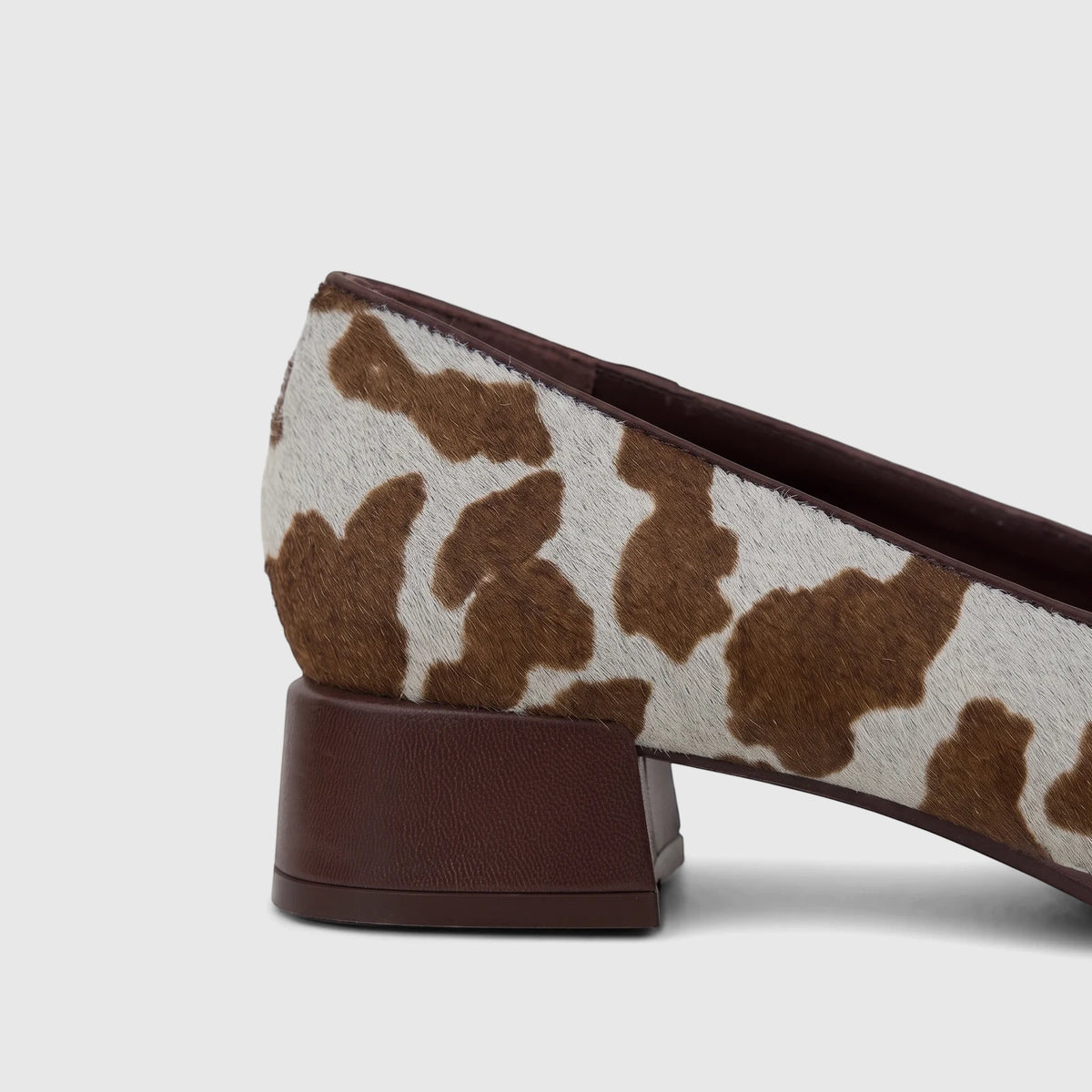 Close-up of a Capelli Rossi Ladies Block Heel Court shoe featuring a brown and white cow hair upper and a stacked brown heel.