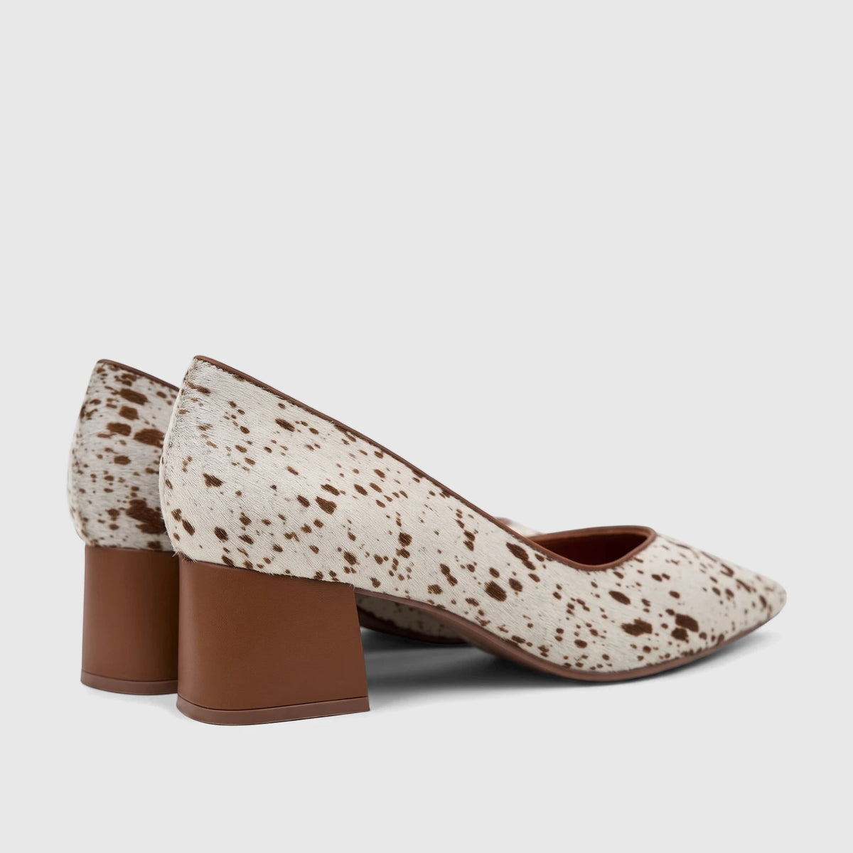 Pair of Capelli Rossi Leather Ladies Block Heel Court shoes in white with brown cowhide pattern, shown from a side view.