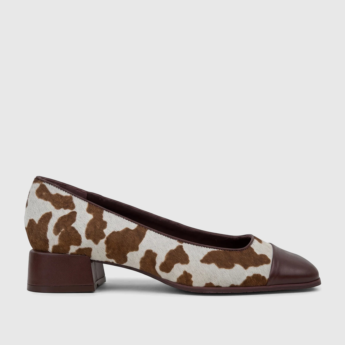 Capelli Rossi leather block heel court shoe featuring a brown pointed toe, brown block heel, and brown cow print