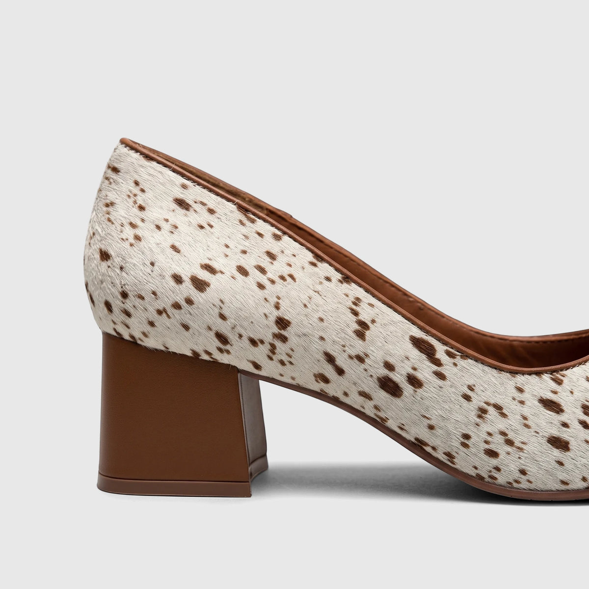 Capelli Rossi Ladies Block Heel Court shoe with white and brown cowhide print upper and solid brown block heel, side view.